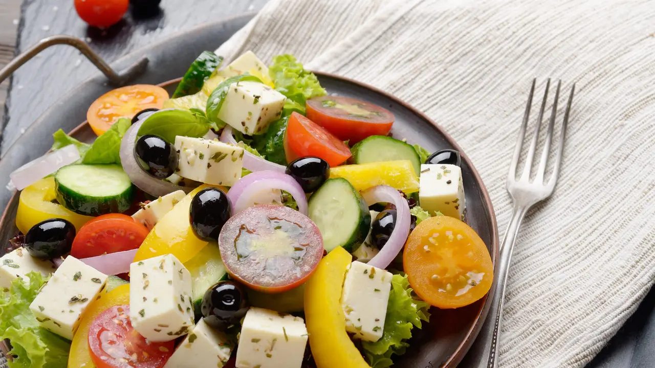 Mediterranean diet dish greek salad on vintage metal tray closeup photo